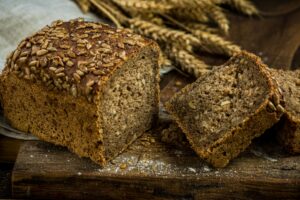 Wholegrain bread with seeds sliced on board